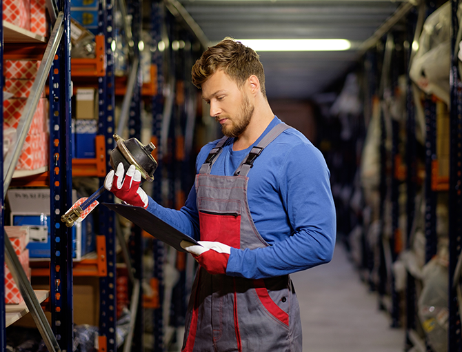 warehouse-worker-checking-inventory-spare-parts