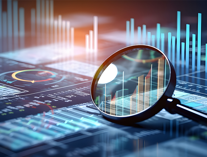 Magnifying glass on digital display of financial charts