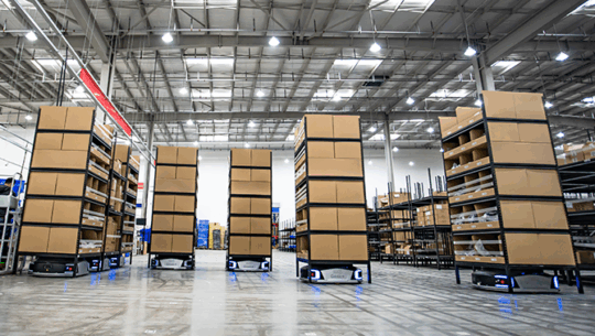 Geekplus robotics system transporting cartons through warehouse - FORTNA