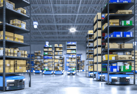 Automated guided vehicles (AGVs) transporting product through warehouse - FORTNA